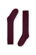 Calcetines burdeos de caña alta con puntitos azul claro, 100 % algodón y logo NAIVE en la puntera; tejidos en España.

