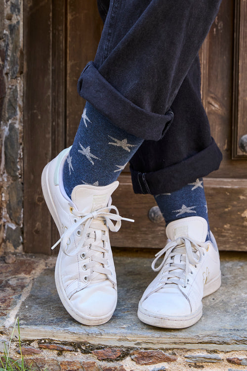 Calcetines premium azul marino con estrellas azul oscuro, caña alta, 90 % algodón y logo NAIVE en la puntera; confeccionados artesanalmente en España.