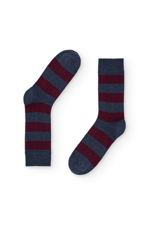 Calcetines de caña media con rayas anchas azul y burdeos estilo rugby, 90 % algodón y logo NAIVE en la puntera; tejidos en España.